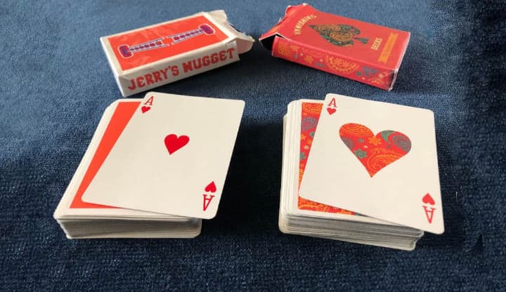 An Ace of Hearts playing card from the Dapper Deck by Vanishing Inc and an Ace of Hearts from Jerry's Nugget Playing Cards perfectly match after a performance of the beginner magic trick Do As I Do.